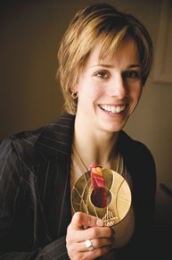 Jennifer Heil flashes a winning smile and a little Olympic bling during a recent trip to Montreal. The management student's decision to take a sabbatical from her studies last year to prepare for the Turin Games paid off in spades - or, at least in gold plate.