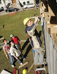 Doing his best Bob the Builder impersonation, Gonzalo Lizarralde, School of Architecture lecturer for the post-disaster reconstruction class, drives a nail into the shelter prototype erected on lower campus.