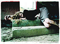 Photograph of a woman lying on steps