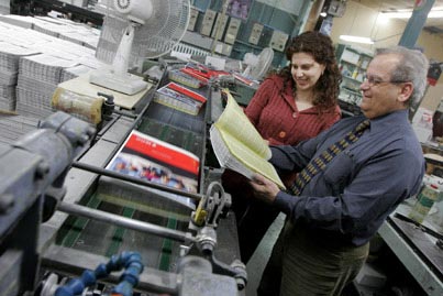 Bonnie Borenstein examines one of next year�s 40,000 undergraduate course calendars with Jean-Pierre Gentile of Payette and Simms printers. Borenstein and her colleagues in the Admissions, Recruitment and Registrar�s office began to prepare the 624-page document in mid-October, and the books will be delivered to campus on March 11. The undergraduate calendar is the largest of the 10 calendars published by ARR. The current online version can be found through www.mcgill.ca/courses.