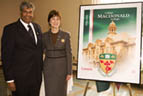 Chandra Madramootoo, Dean of the Faculty of Agricultural and Environmental Sciences at McGill's Macdonald Campus, helps McGill Principal and Vice-Chancellor Heather Munroe-Blum unveil a Canada Post stamp commemorating the campus's 100th anniversary