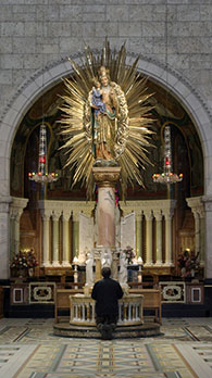 Photo of a man praying in a church
